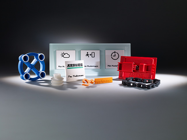 The Freeformer manufactures fully functional one-off parts or multi-variant small-volume batches. At the Hanover Fair 2015 it will individualise rocker-type light switches with a symbol/name combination (centre)
